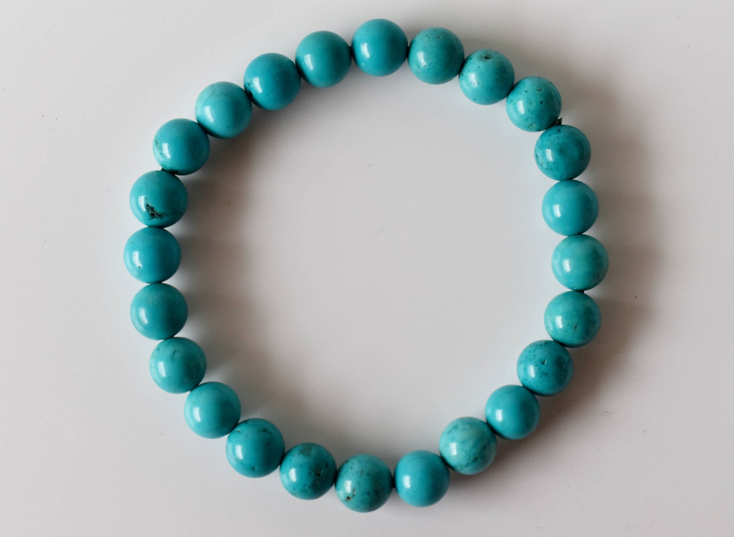 Turquoise beaded bracelet on a light gray background