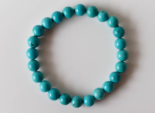 Turquoise beaded bracelet on a light gray background