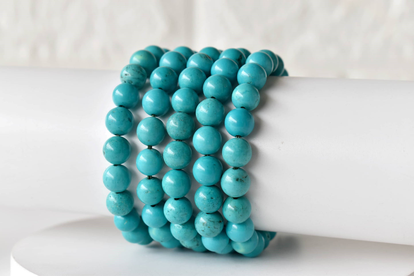 Turquoise beaded bracelet on a white surface