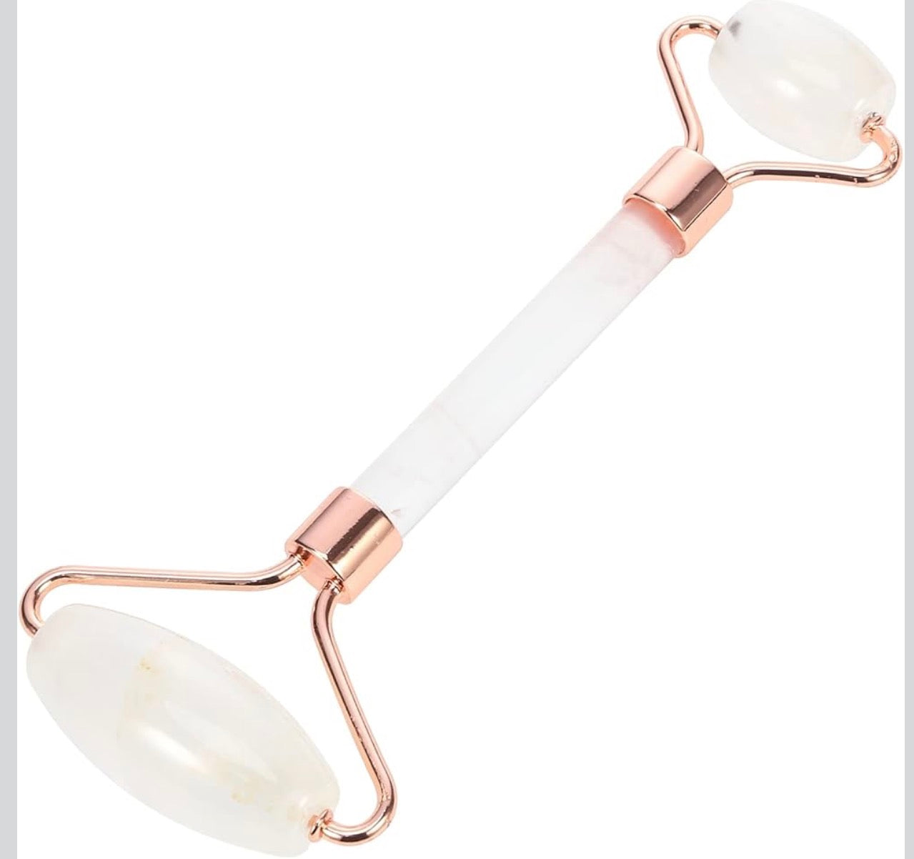 Facial roller with white stones and rose gold accents on a white background