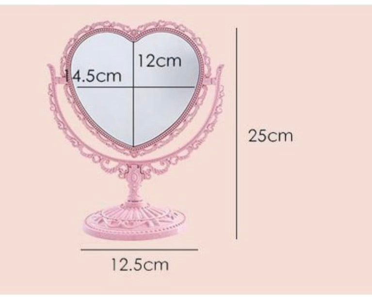 Heart-shaped mirror with measurements on a pink background